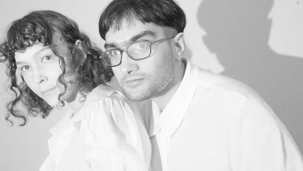 A black and white image of a young female and male artist, Saw-mon and Natalie.